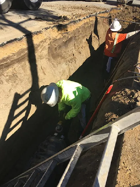 Construction Workers Digging a hole