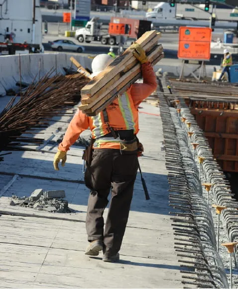 Construction worker carrying heavy materials