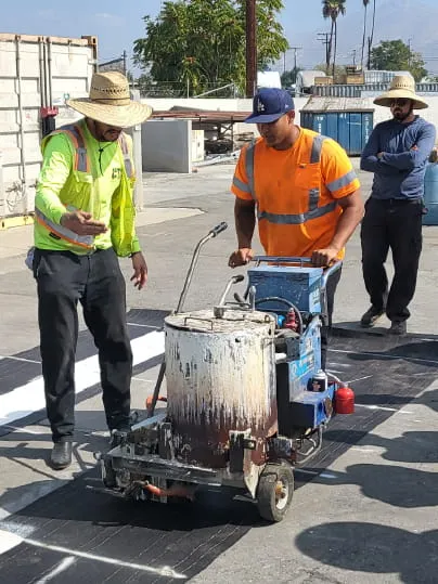 Construction workers painting the floor